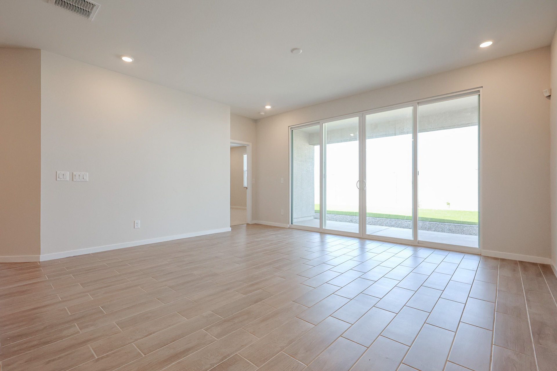 A room with a tile floor and windows.