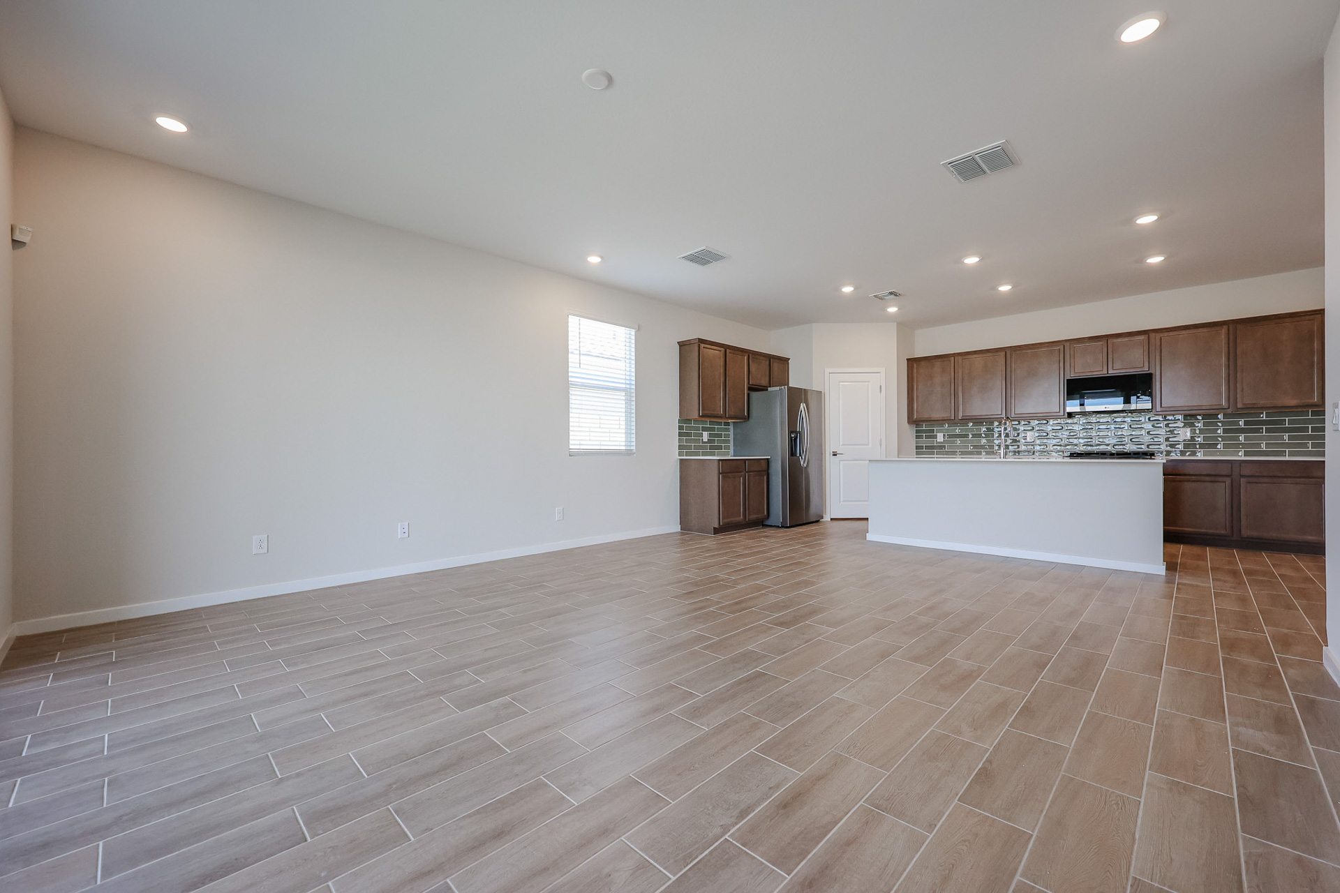A large kitchen with wood floors.