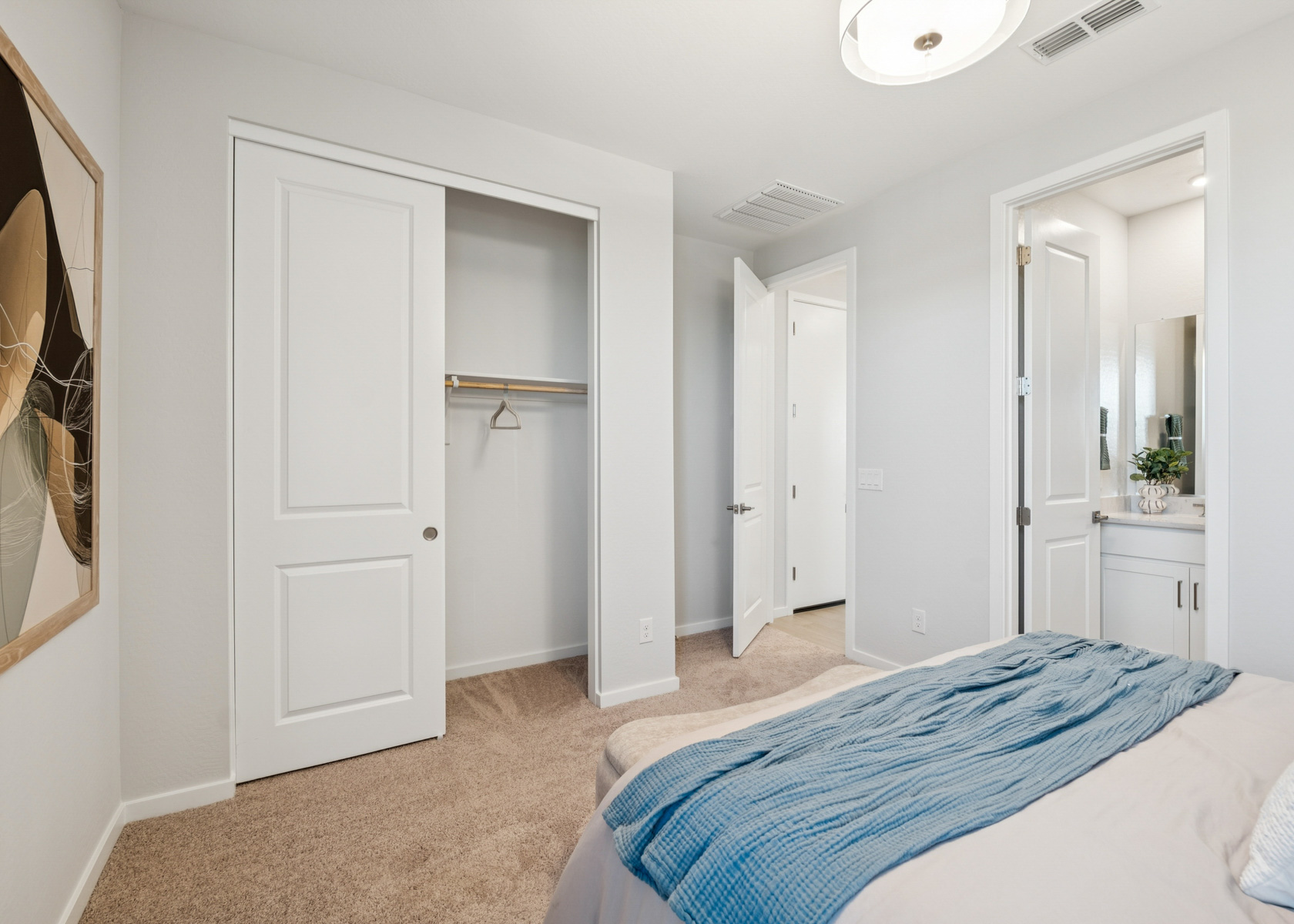 A bedroom with white doors.