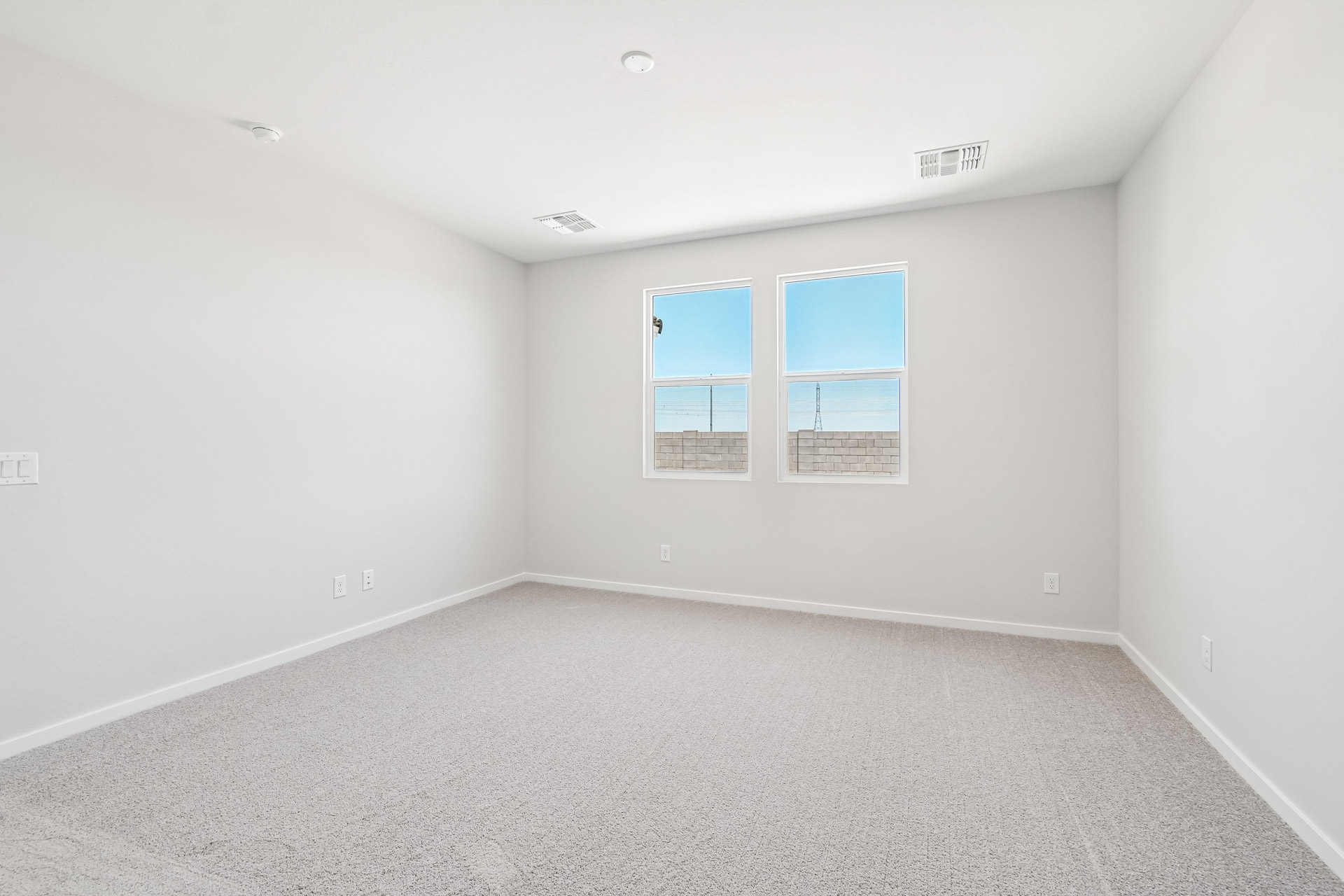 A white room with a window.