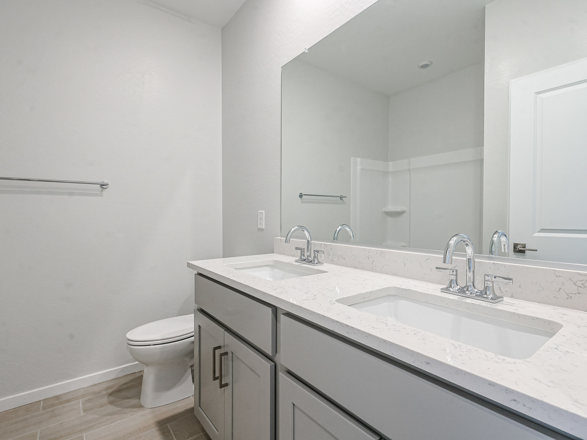 A bathroom with a large mirror.