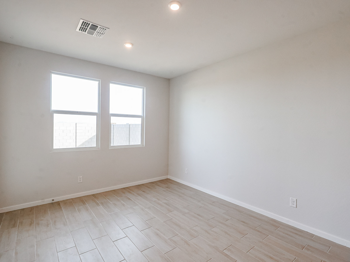 A room with a tile floor and windows.