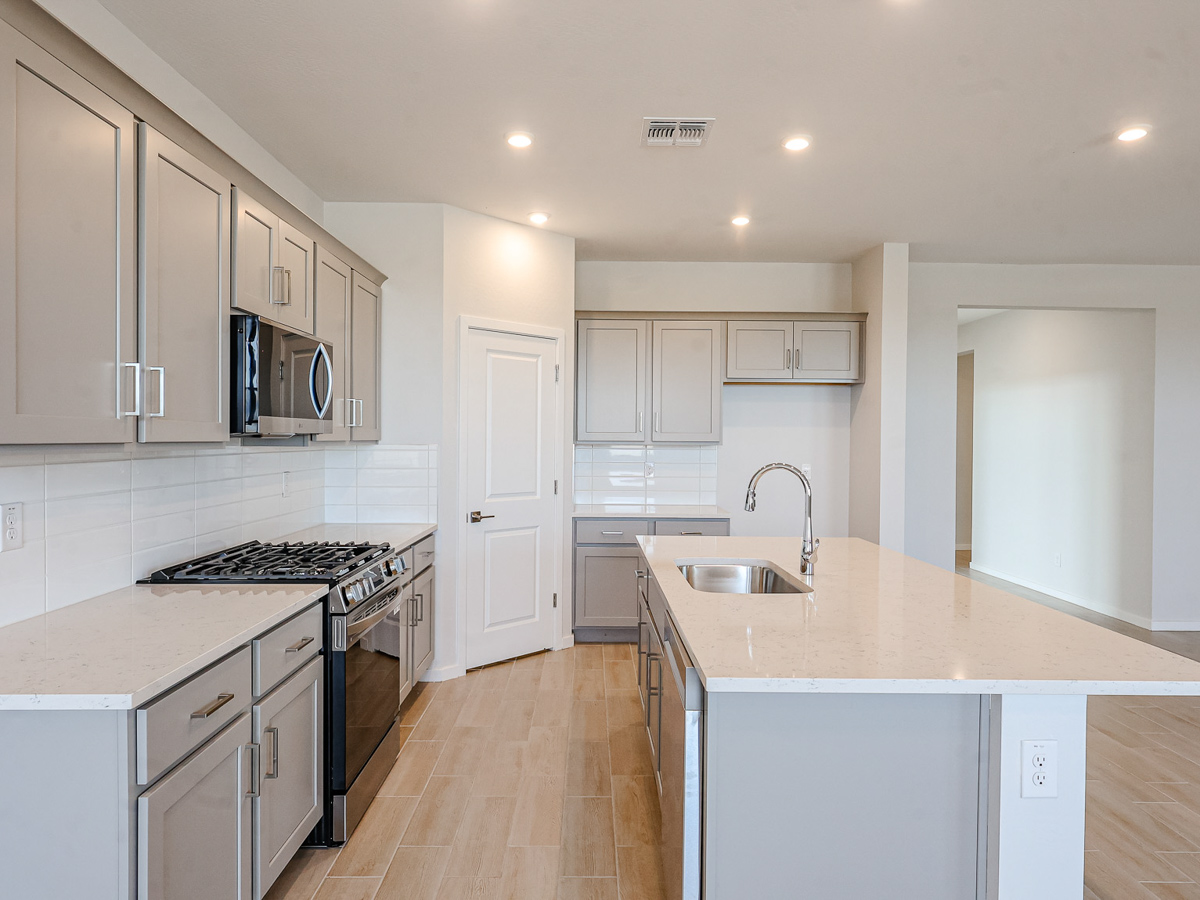 A kitchen with white cabinets.