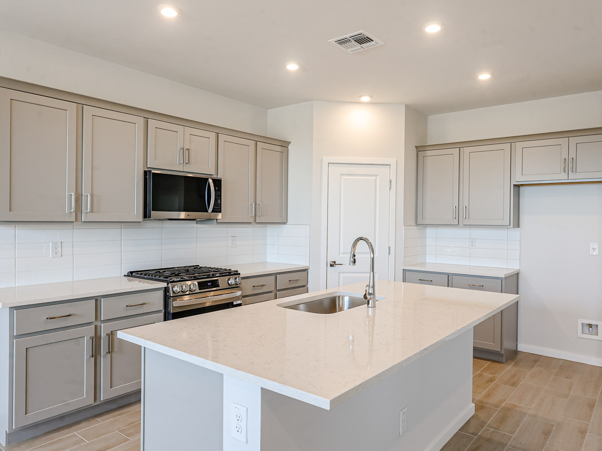 A kitchen with white cabinets.