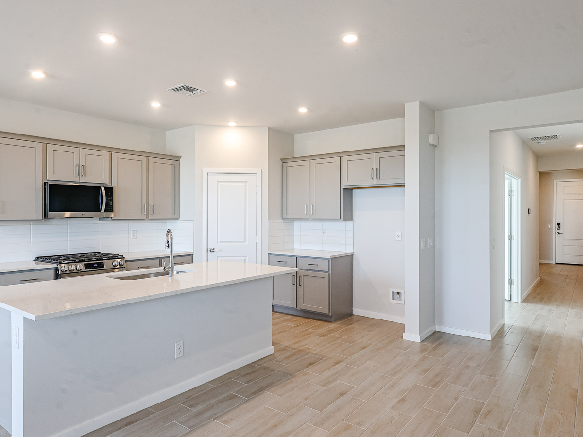 A kitchen with white cabinets.
