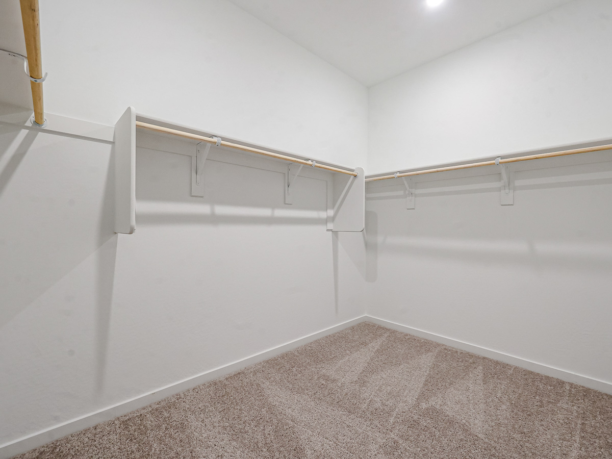 A white wall with a metal bar.