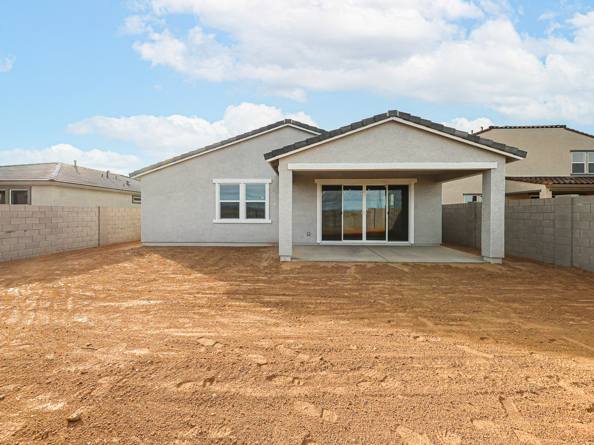 A house with a dirt yard.