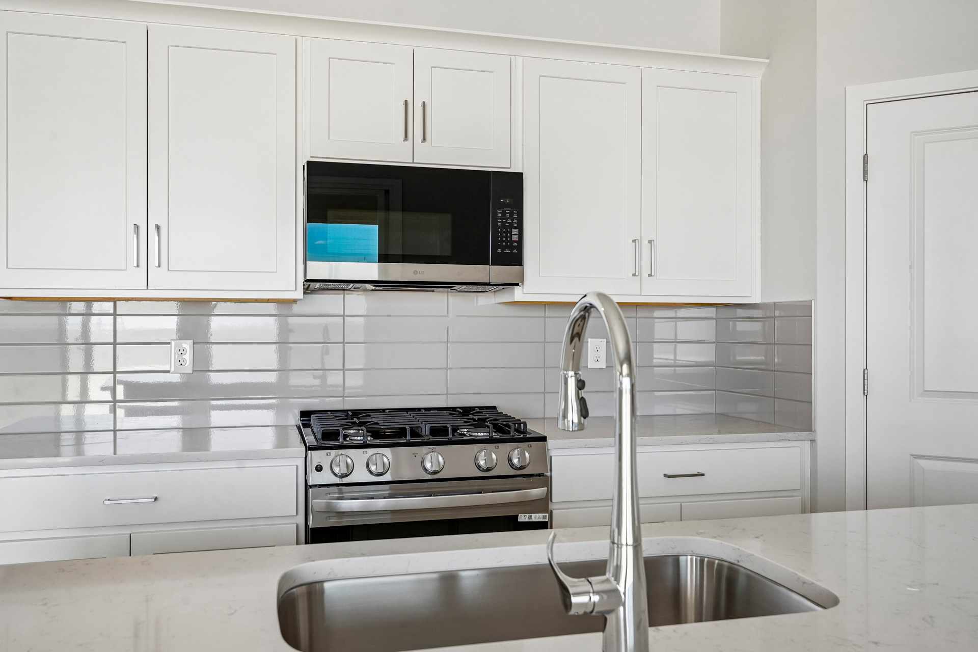 A kitchen with white cabinets.