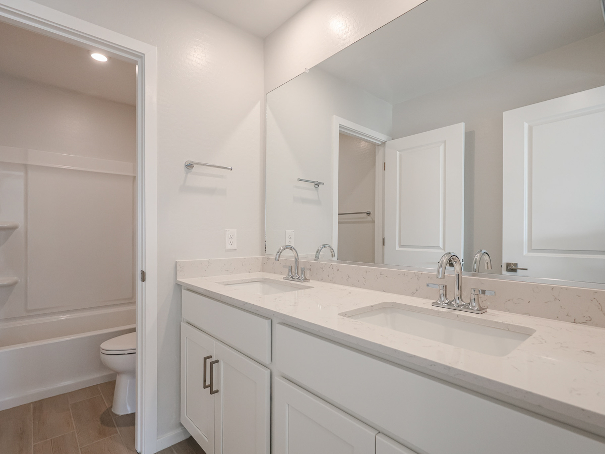 A bathroom with a sink toilet and bathtub.