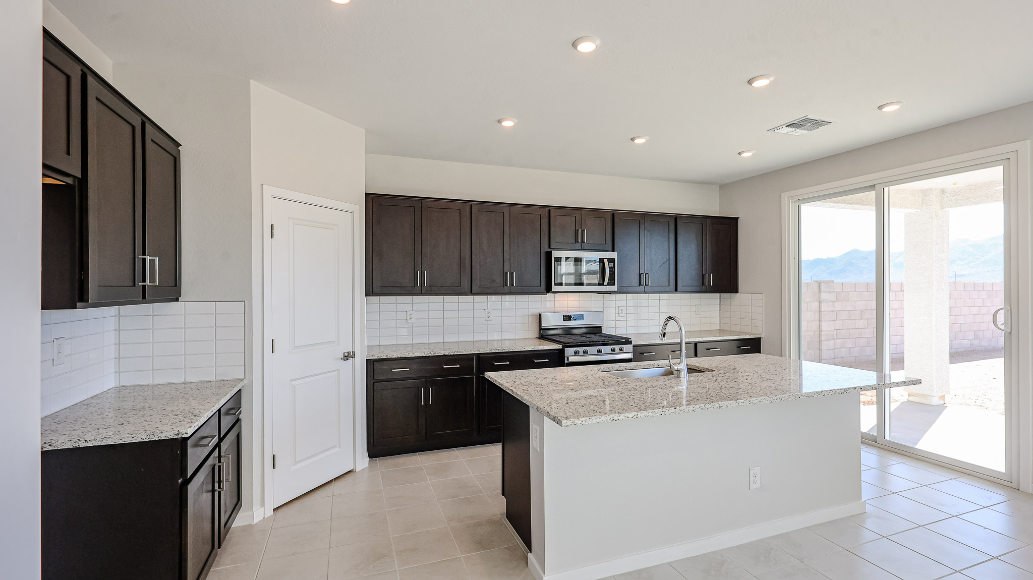 A kitchen with black cabinets.