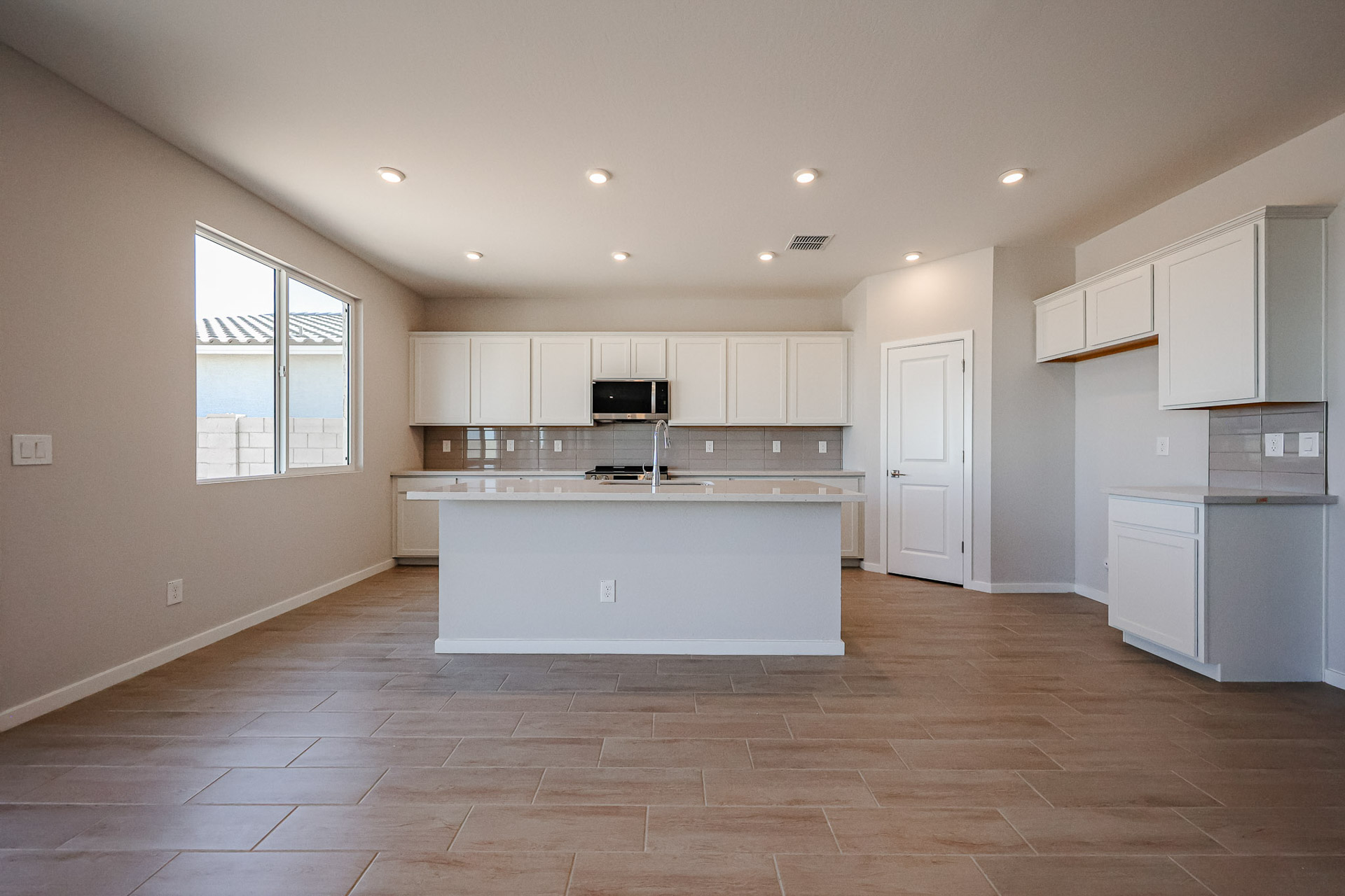 A kitchen with white cabinets.