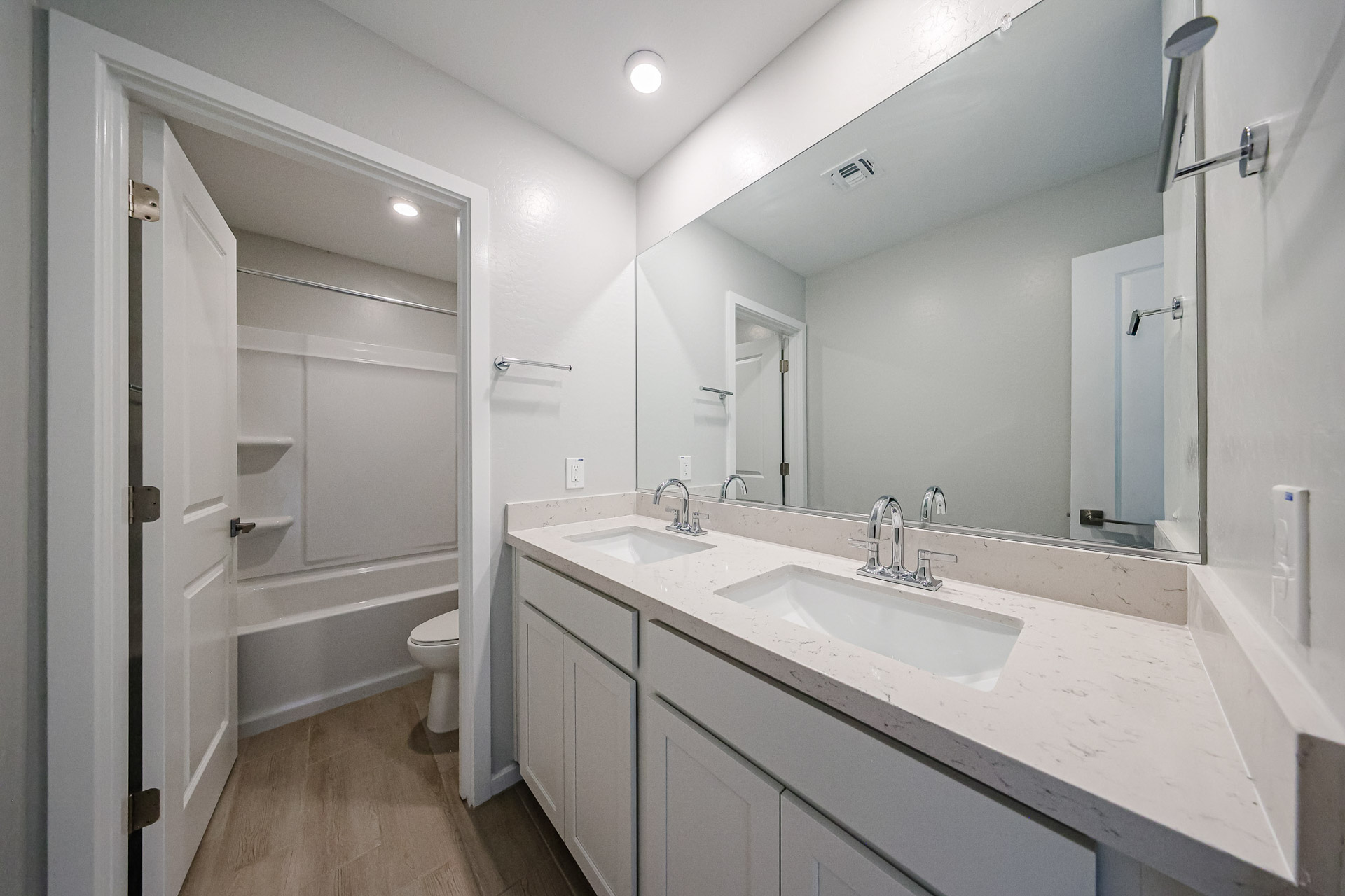 A bathroom with a large mirror.