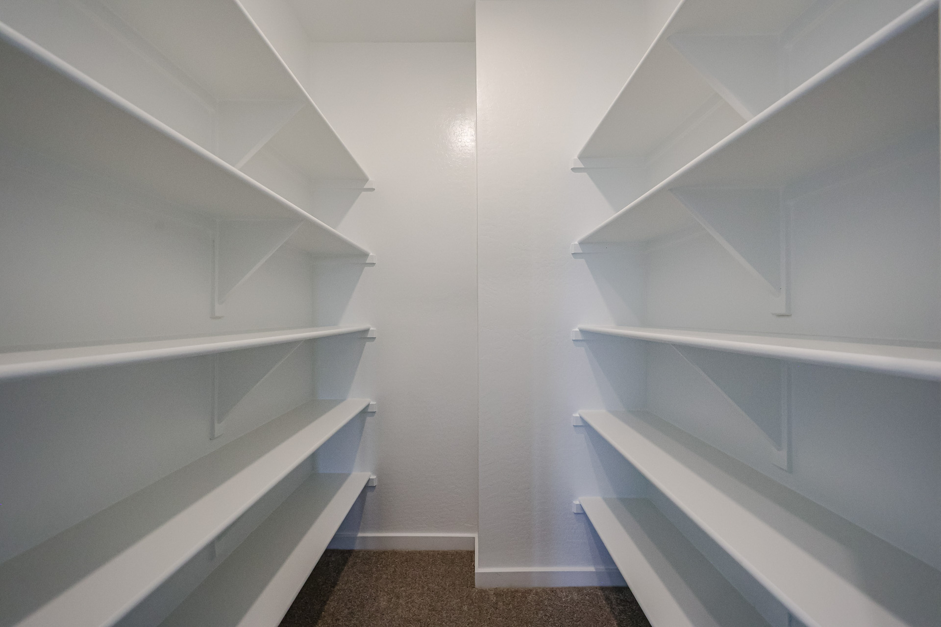 A white staircase with white walls.