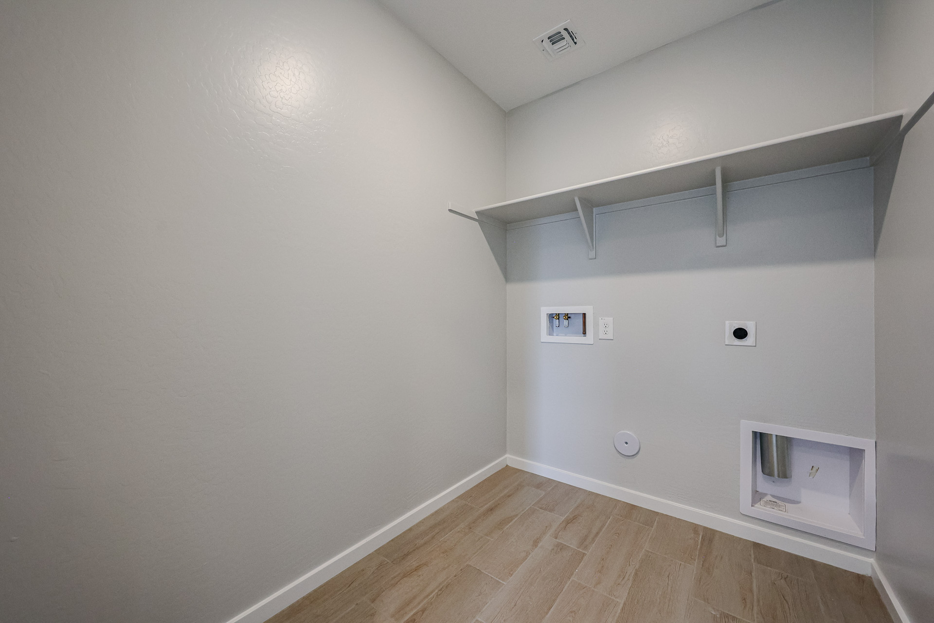 A room with a wood floor and white walls.