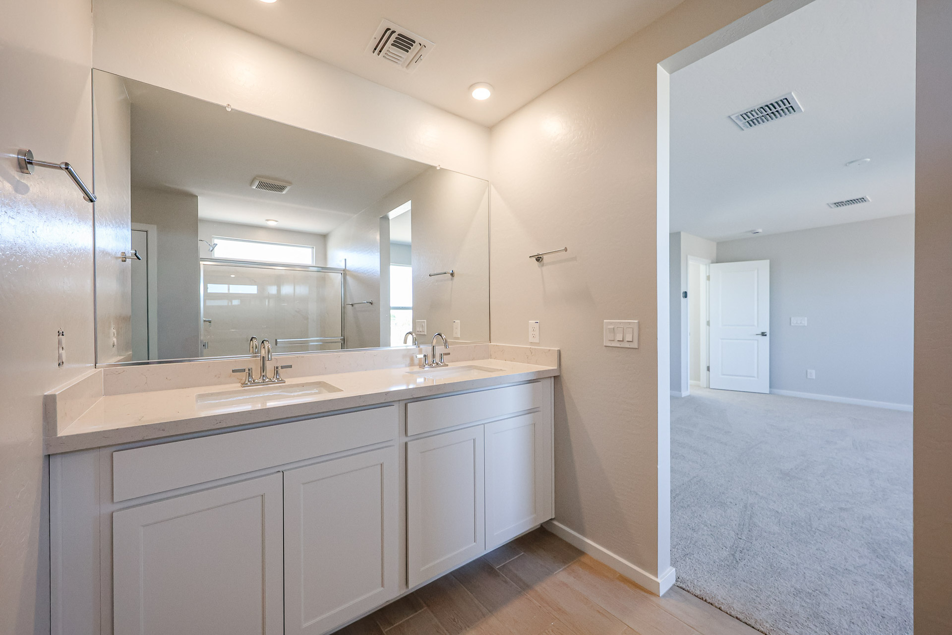 A bathroom with white cabinets.