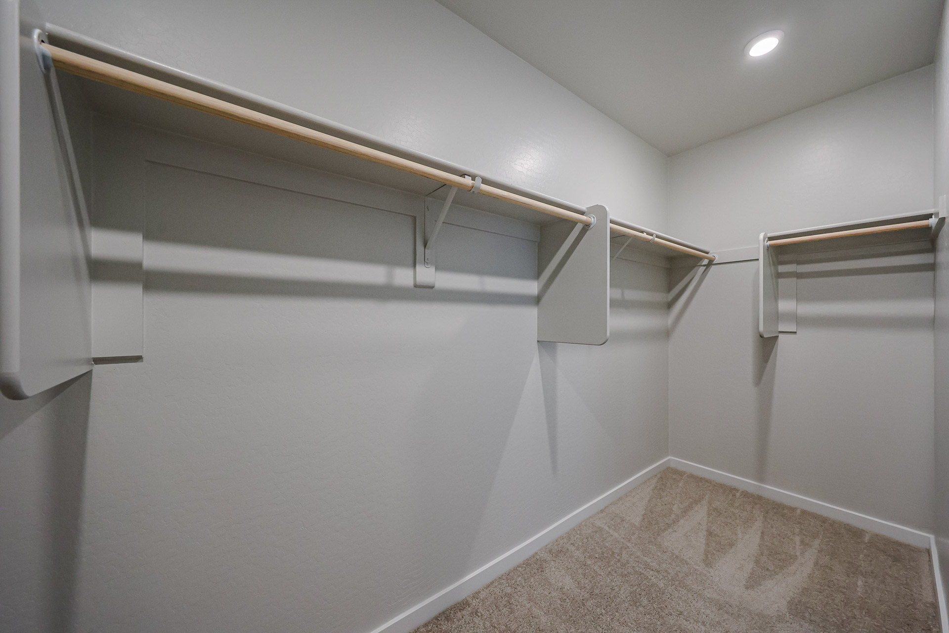 A white wall with a metal railing.