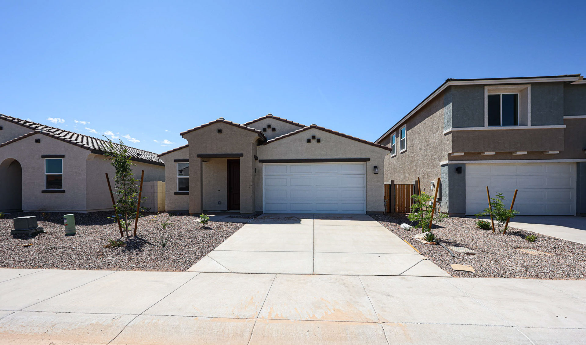 A building with garages and a brick driveway.