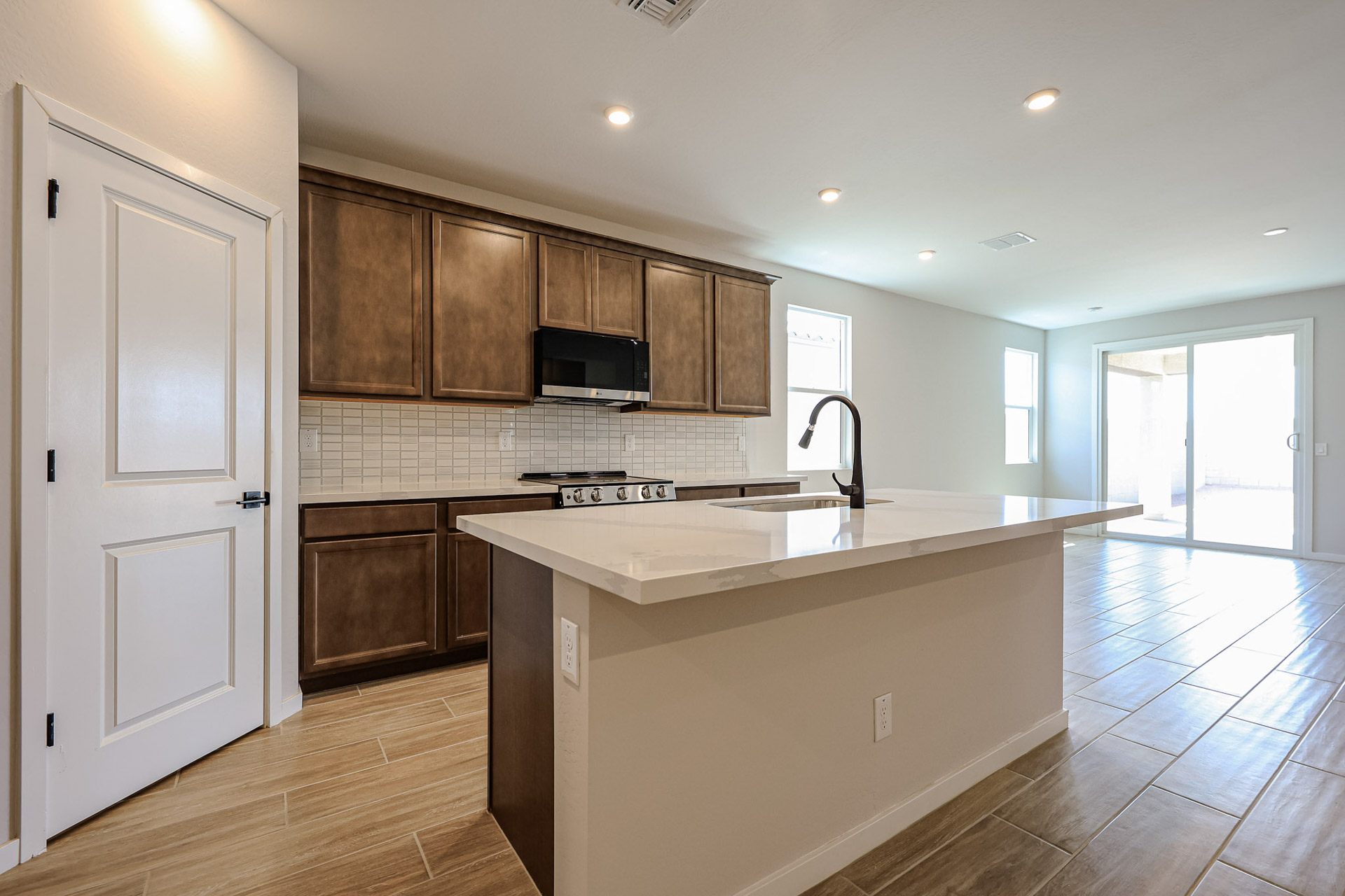 A kitchen with wooden cabinets.