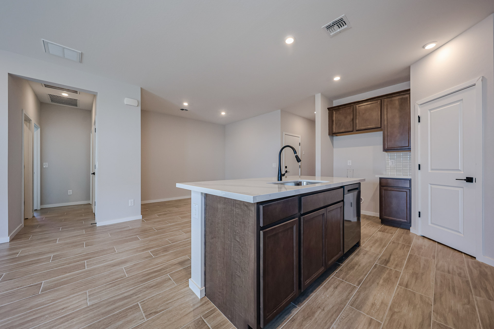 A kitchen with wooden cabinets.