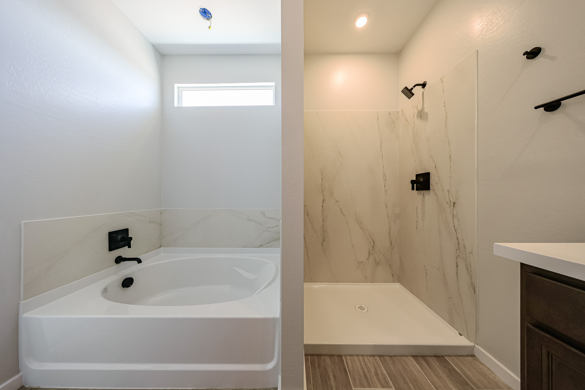 A bathroom with a bathtub and sink.