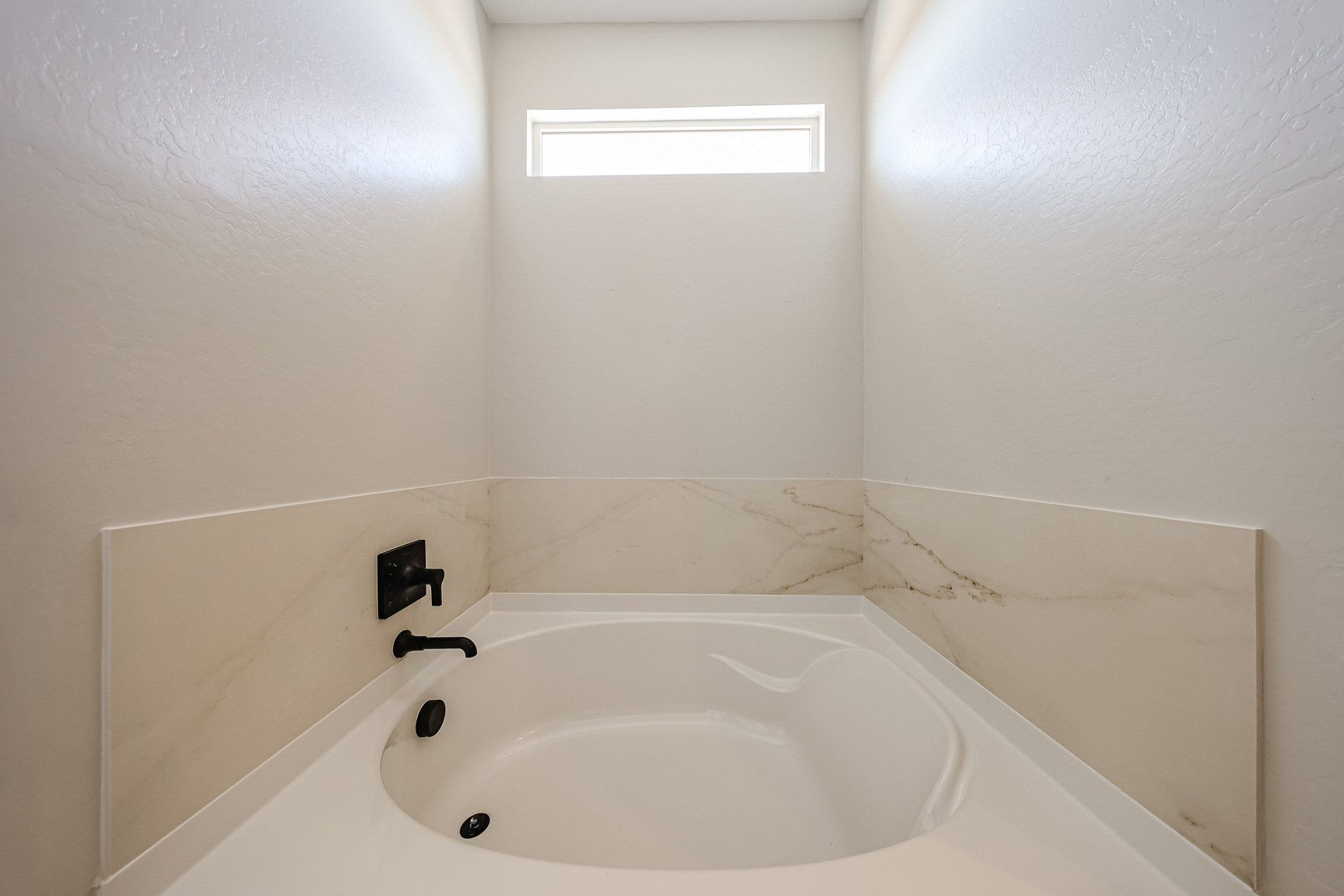 A white sink in a bathroom.