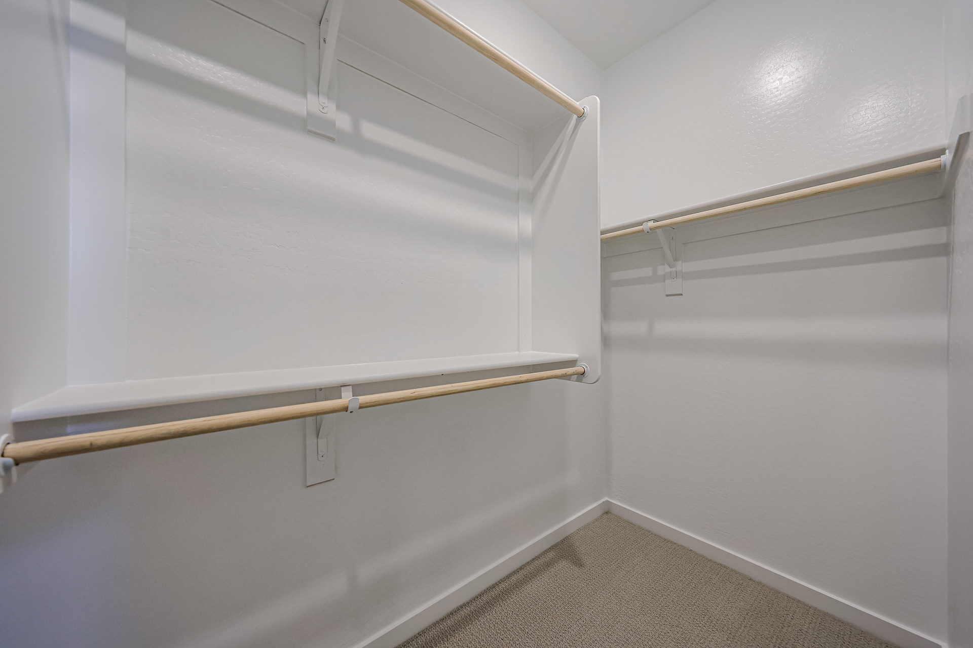 A white wall with a metal bar.