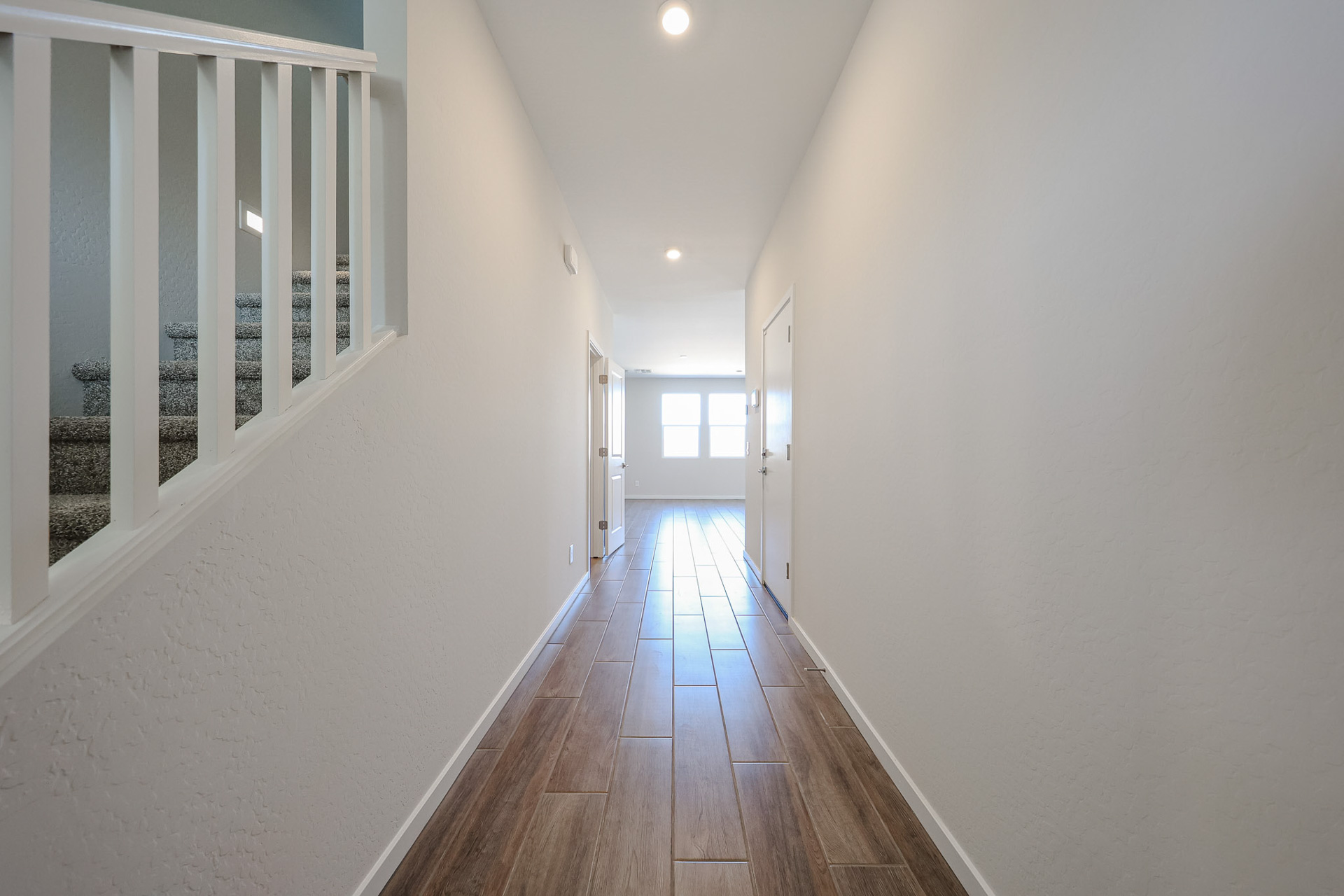 A long hallway with white walls.