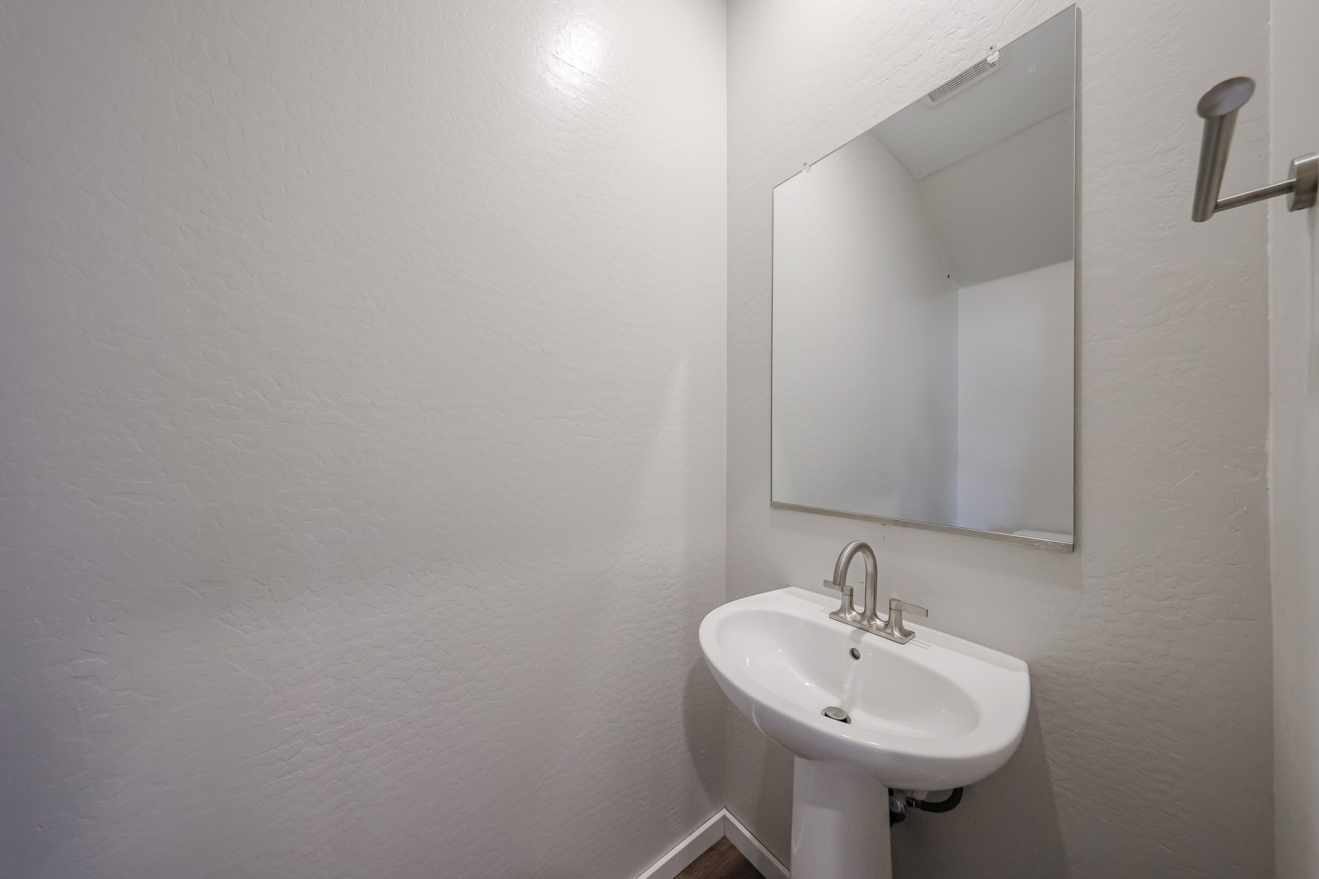 A bathroom with a mirror and sink.