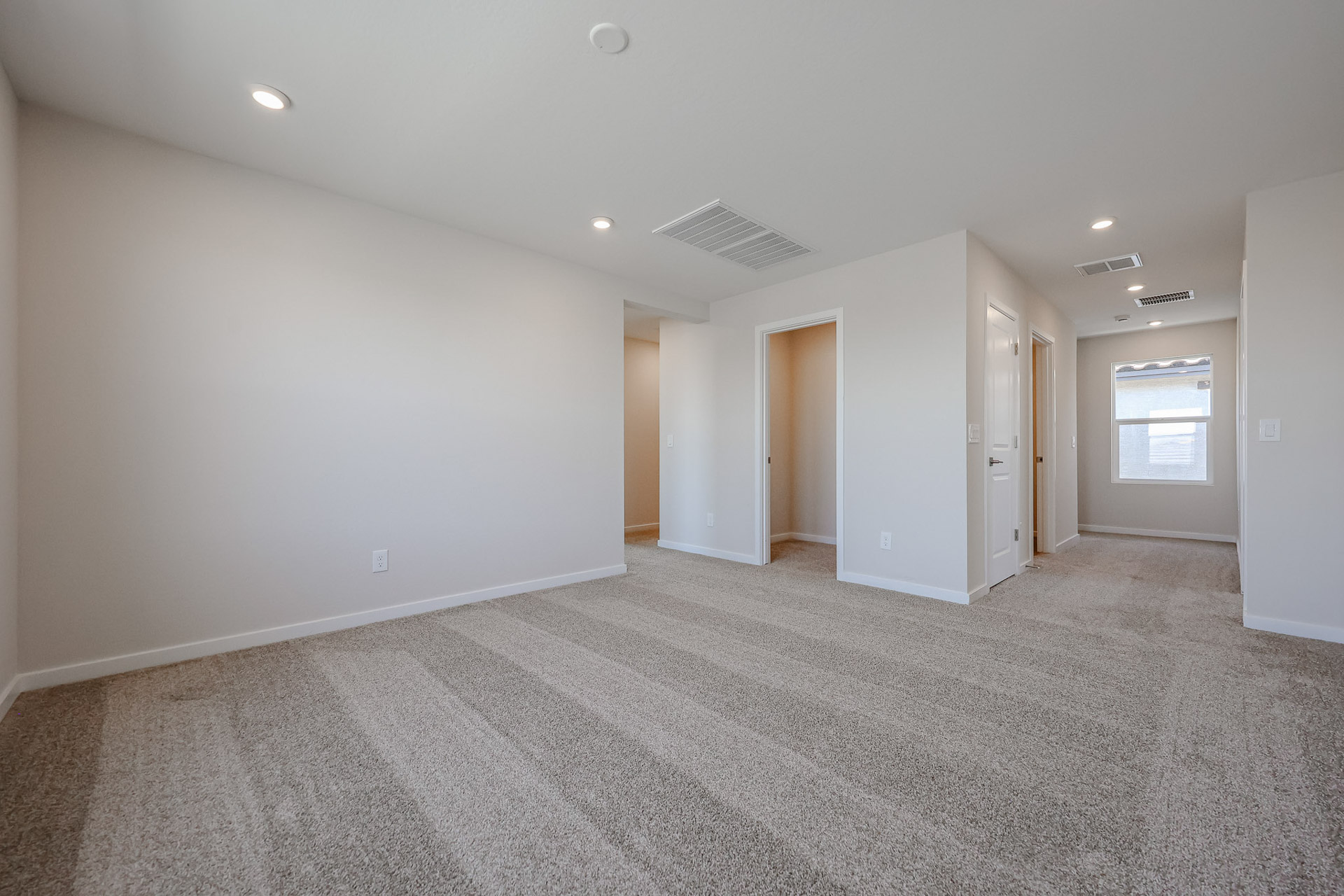 A room with white walls and a carpeted floor.
