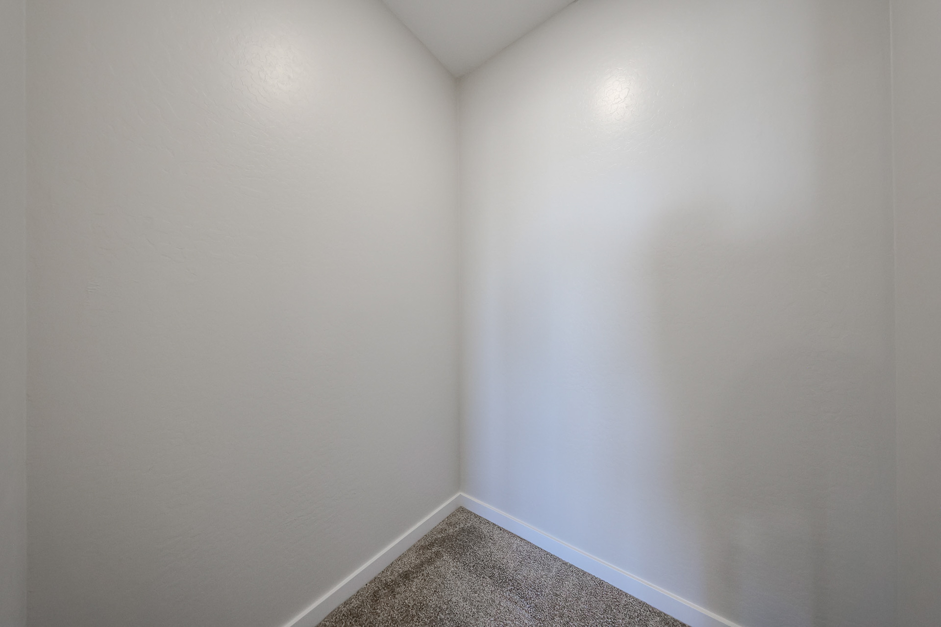 A hallway with white walls.