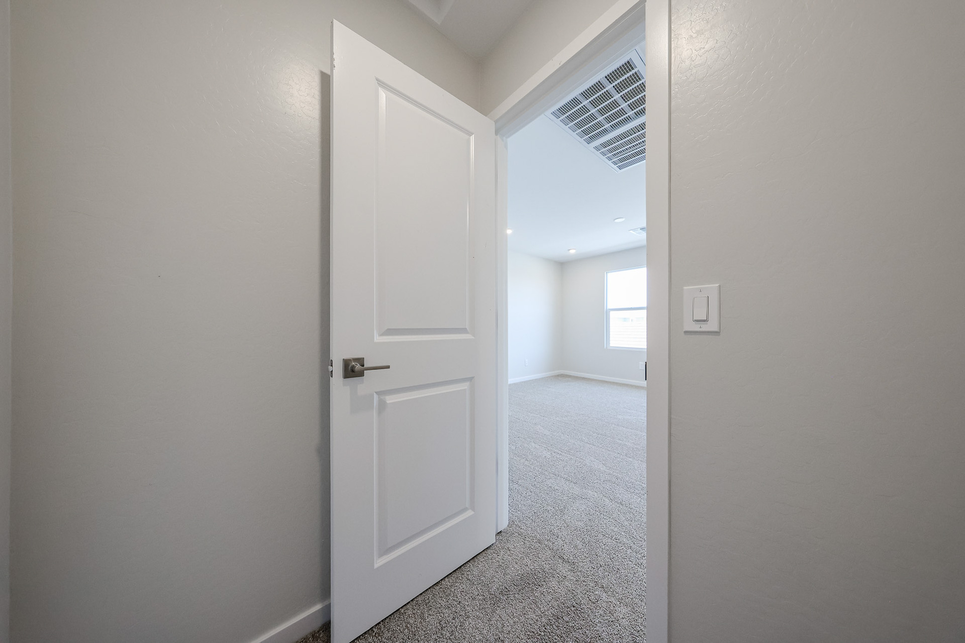 A hallway with white doors.