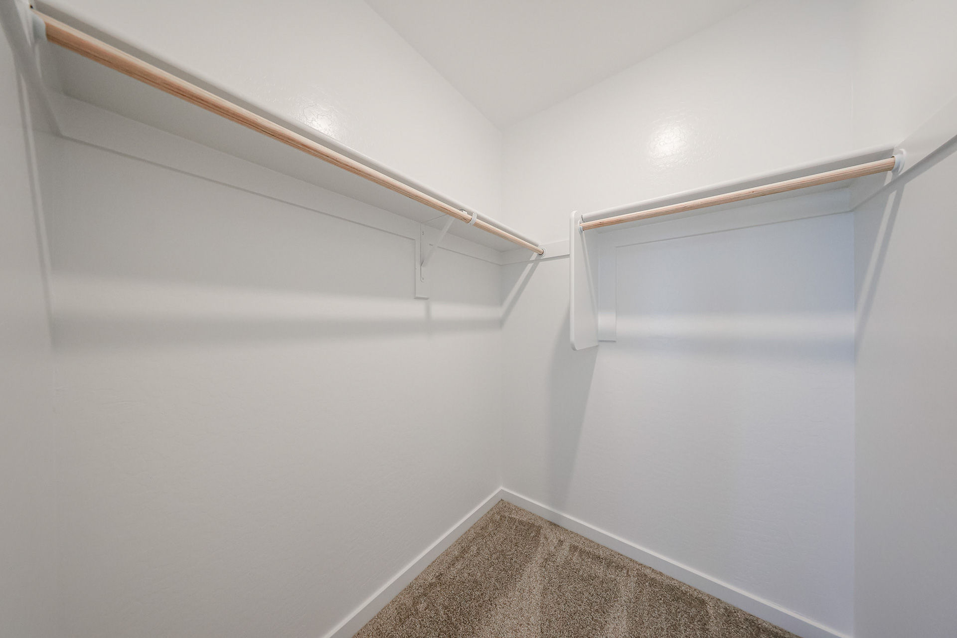 A white wall with a metal railing.