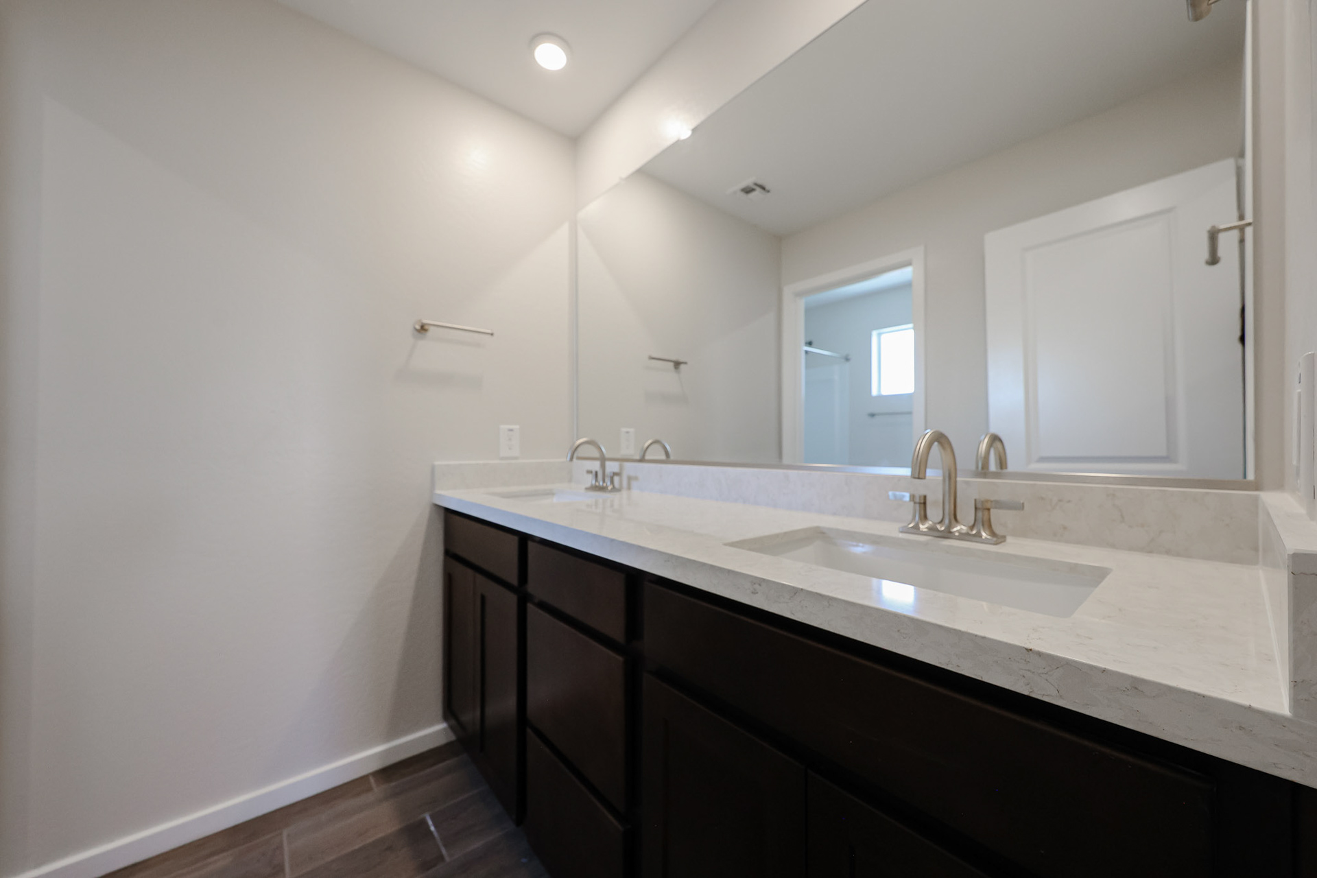 A bathroom with a large mirror.