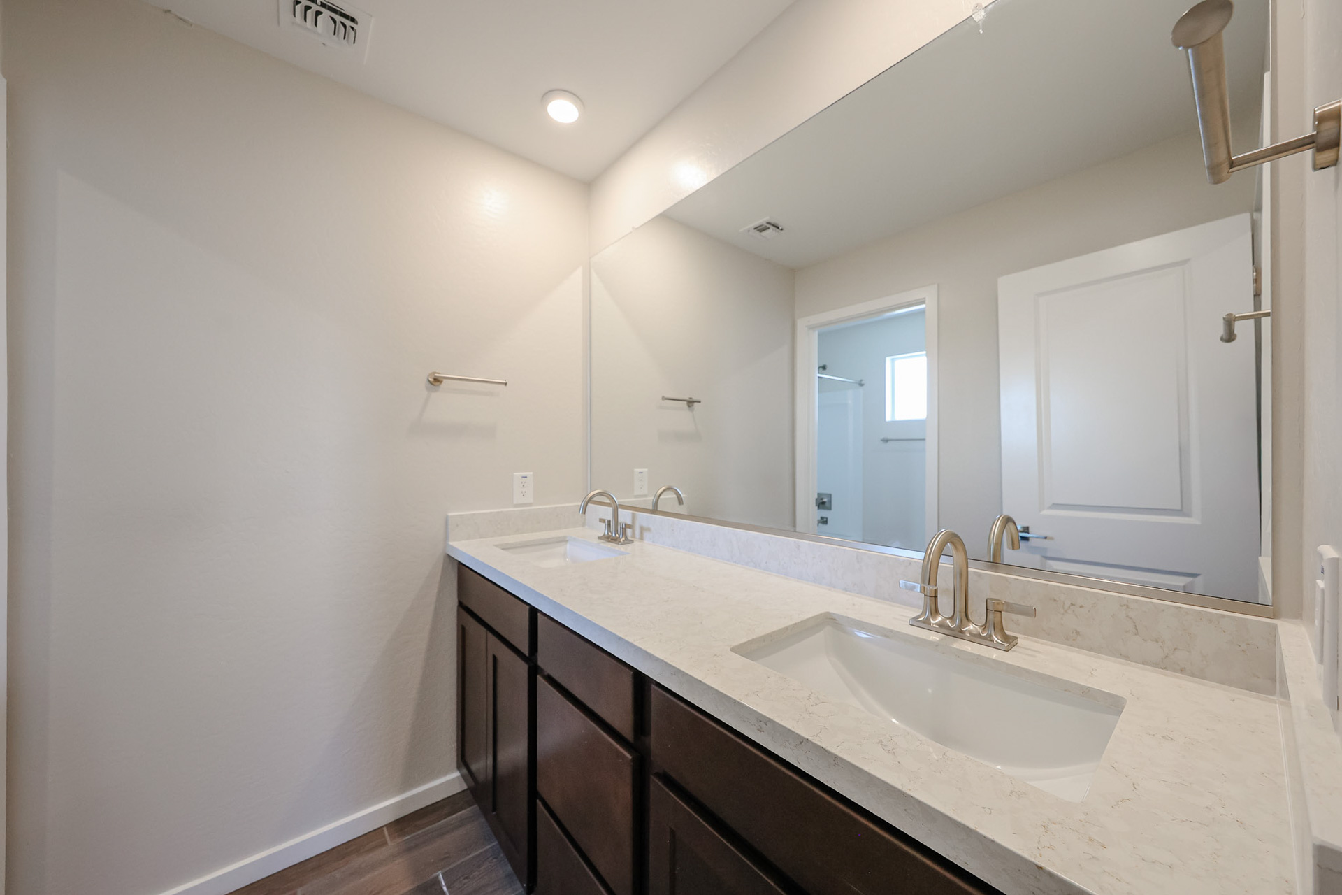 A bathroom with a large mirror.
