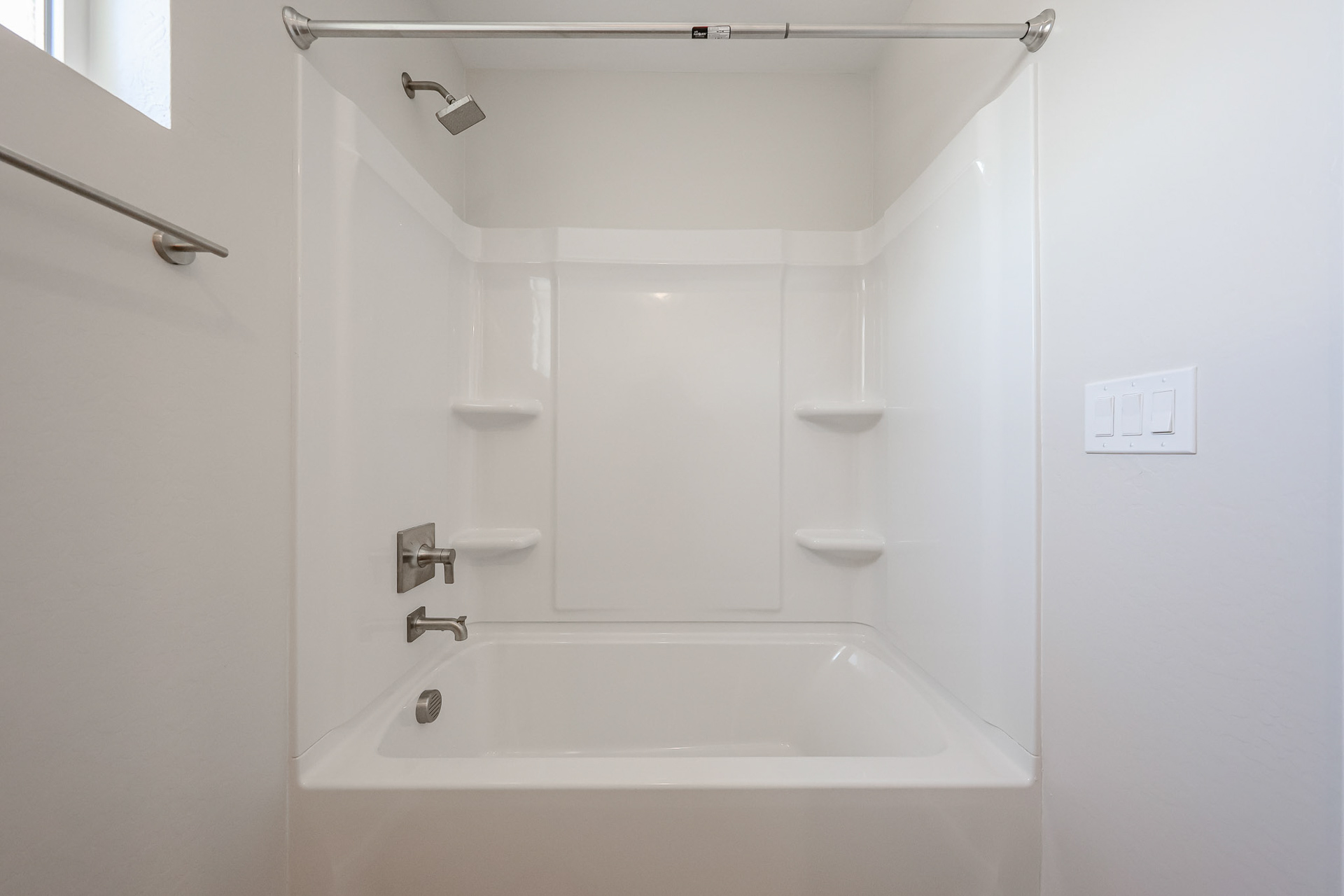 A bathtub in a bathroom.