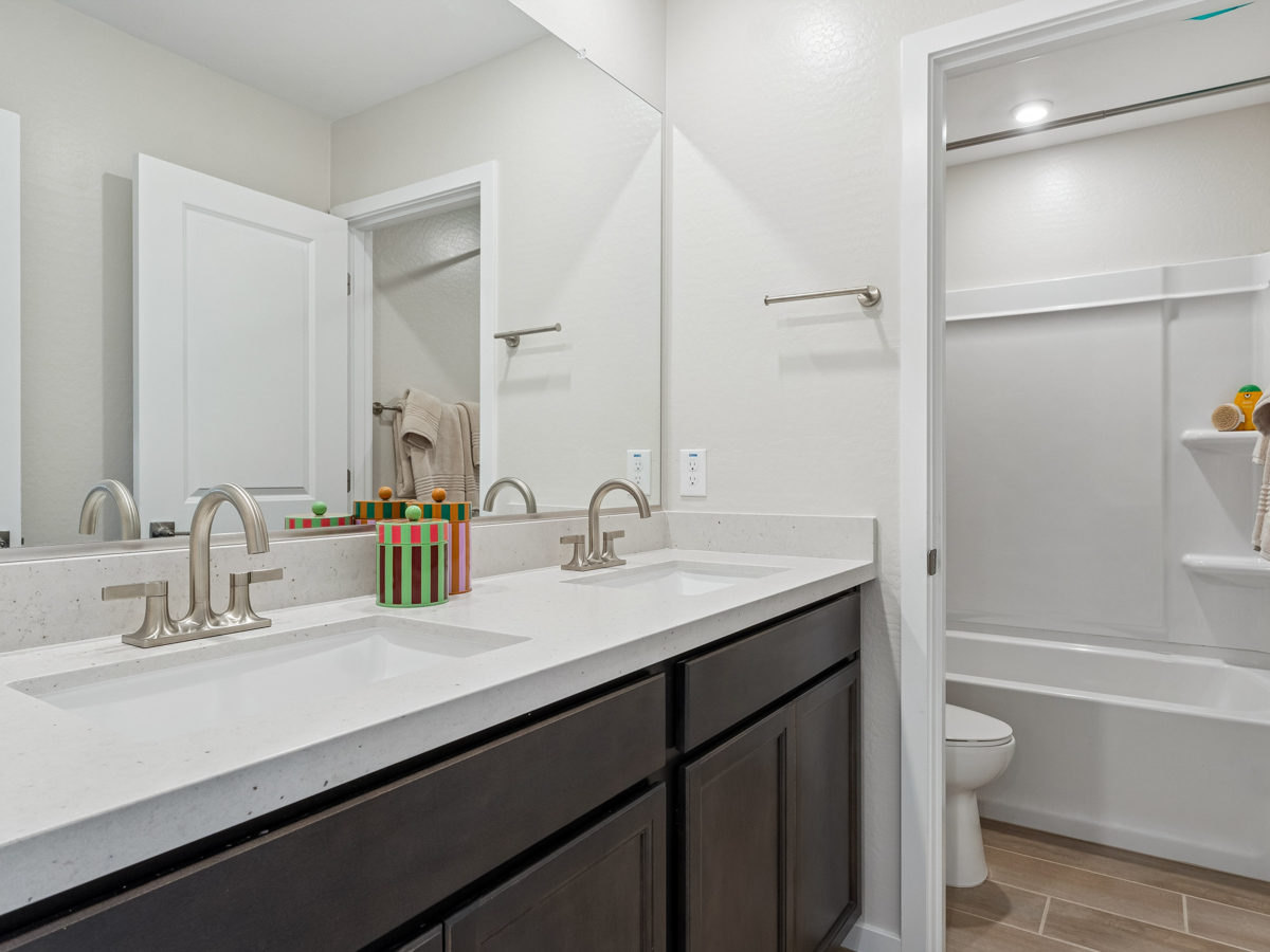 A bathroom with a tub sink and toilet.