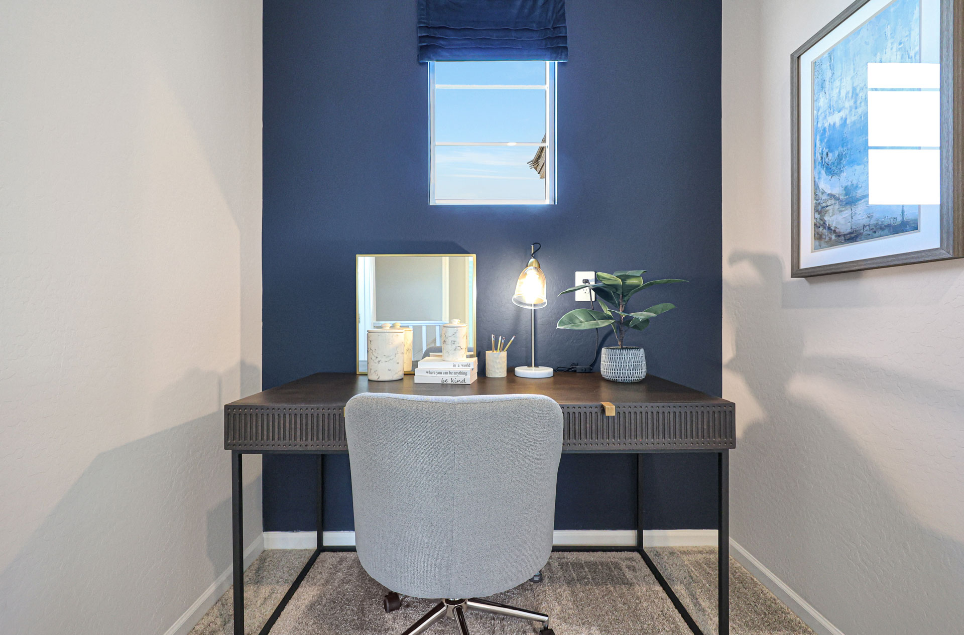 A desk with a chair and a lamp on it.