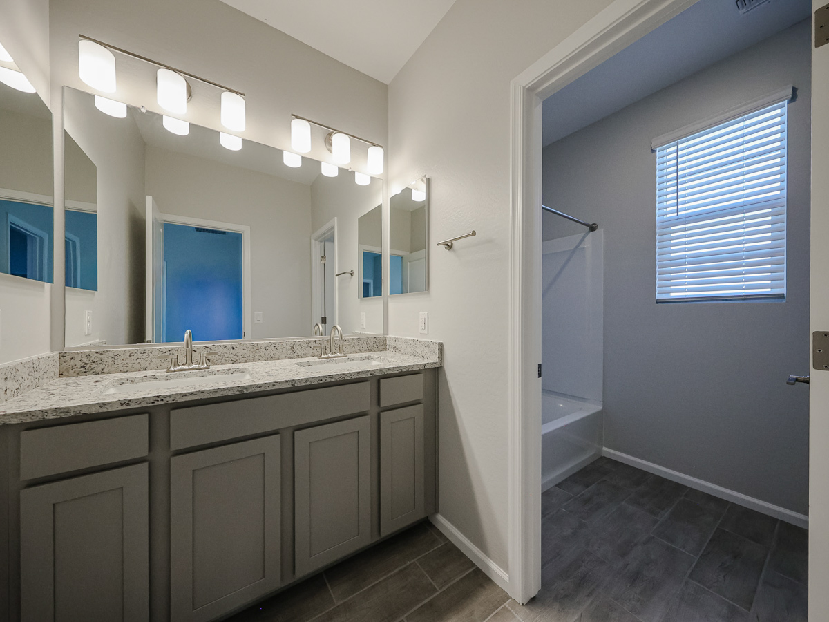 A bathroom with a marble countertop.