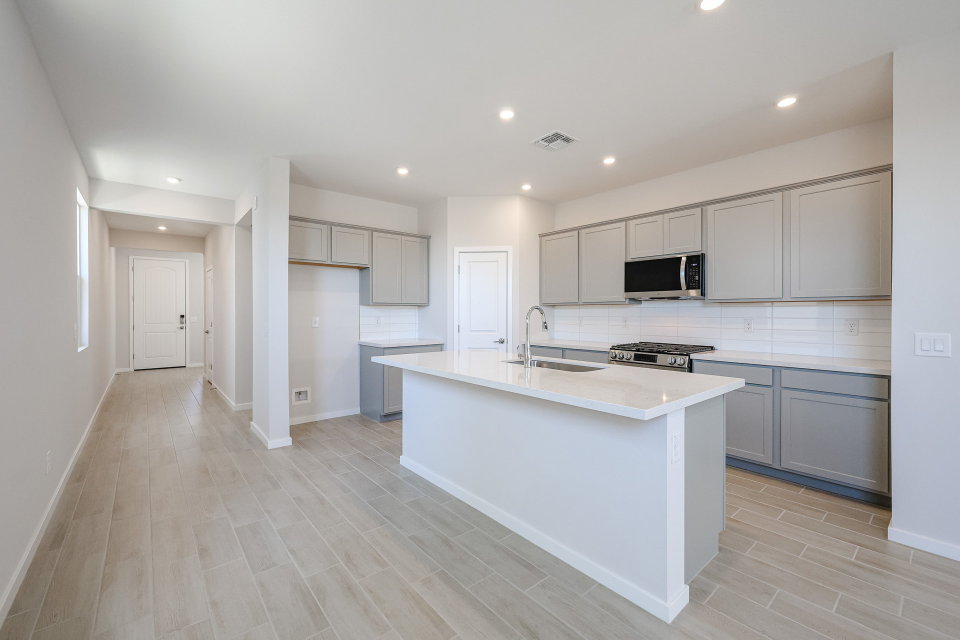 A kitchen with white cabinets.