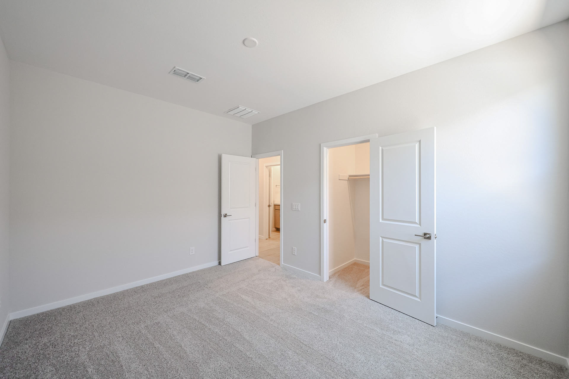A hallway with white doors.