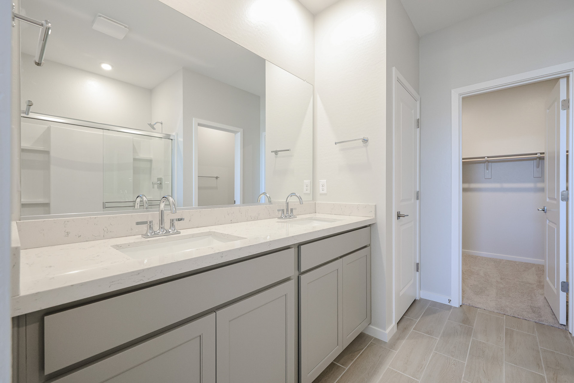 A bathroom with a large mirror.