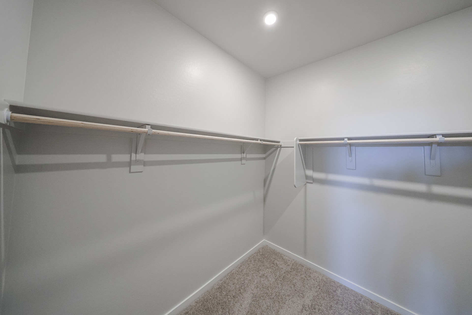 A white room with a metal railing.