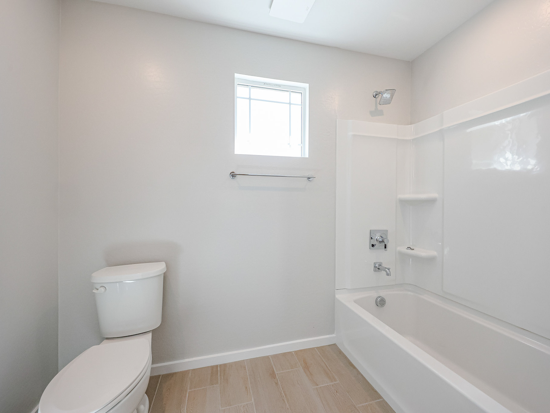 A bathroom with a tub toilet and sink.