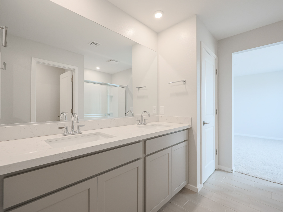 A bathroom with a large mirror.