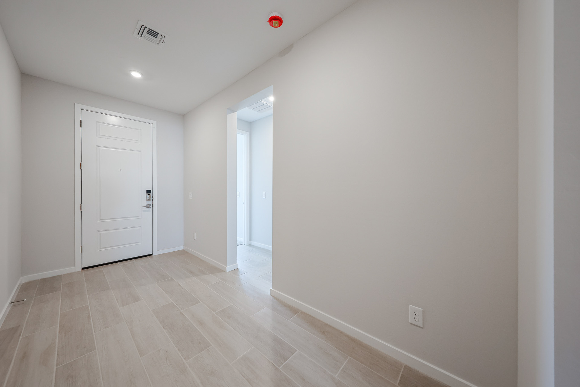 A hallway with white doors.