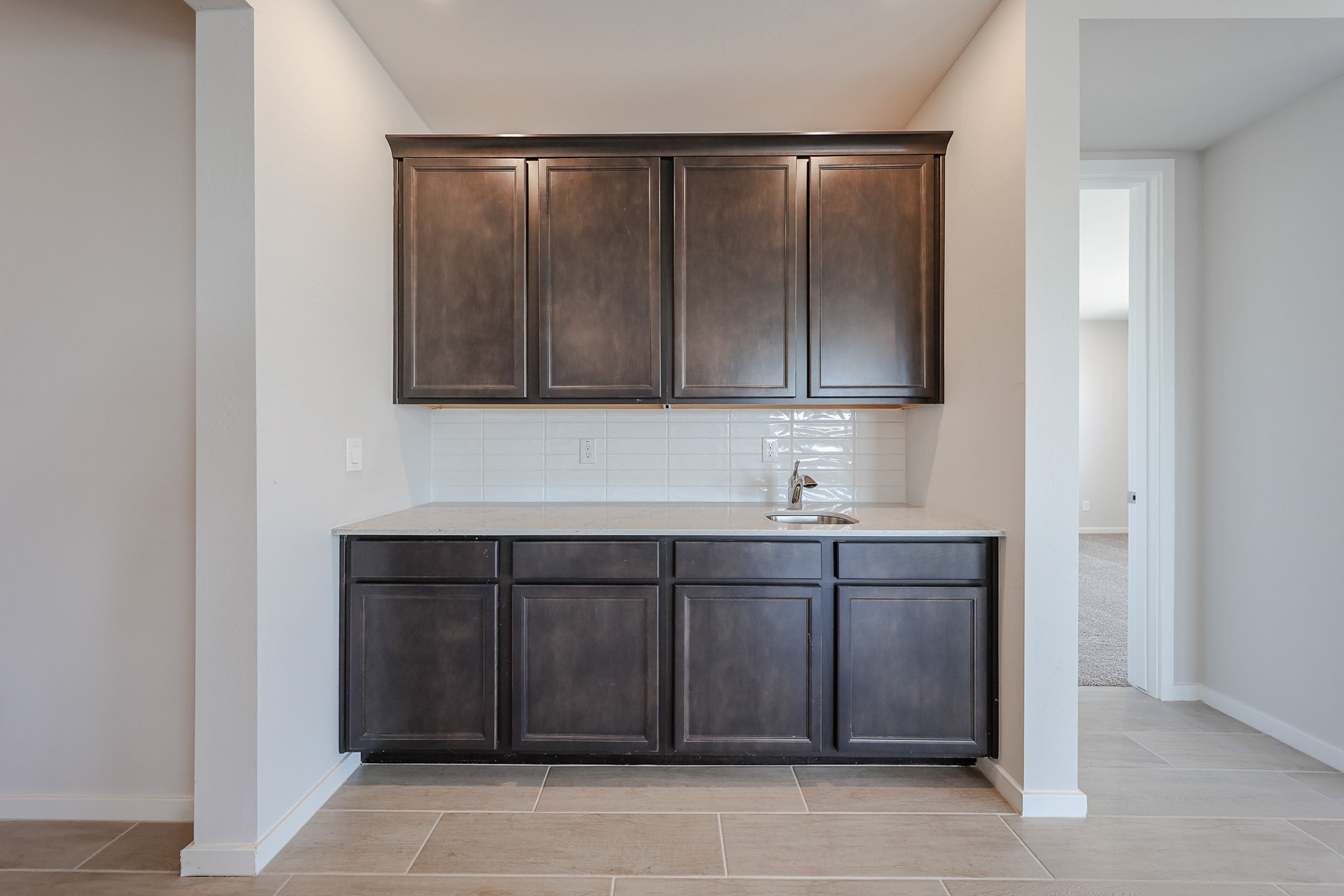 A kitchen with black cabinets.