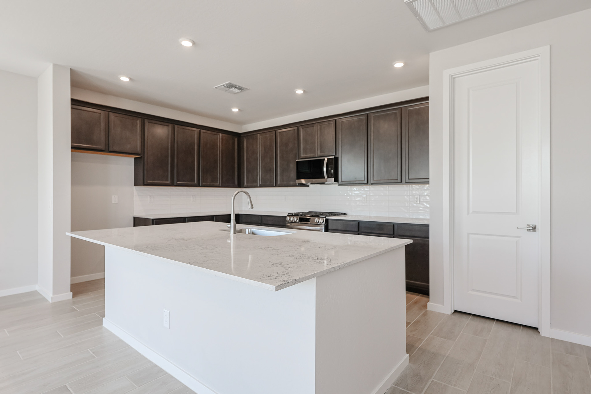 A kitchen with black cabinets.