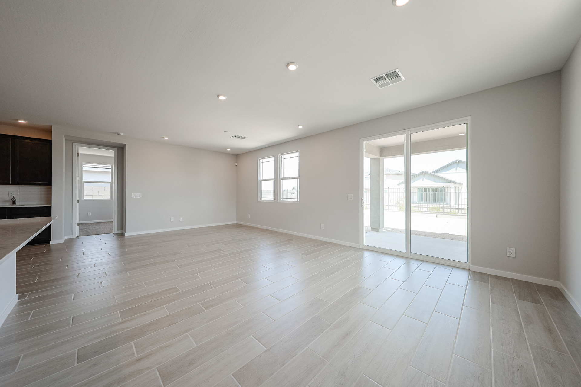 A large empty room with a wood floor.