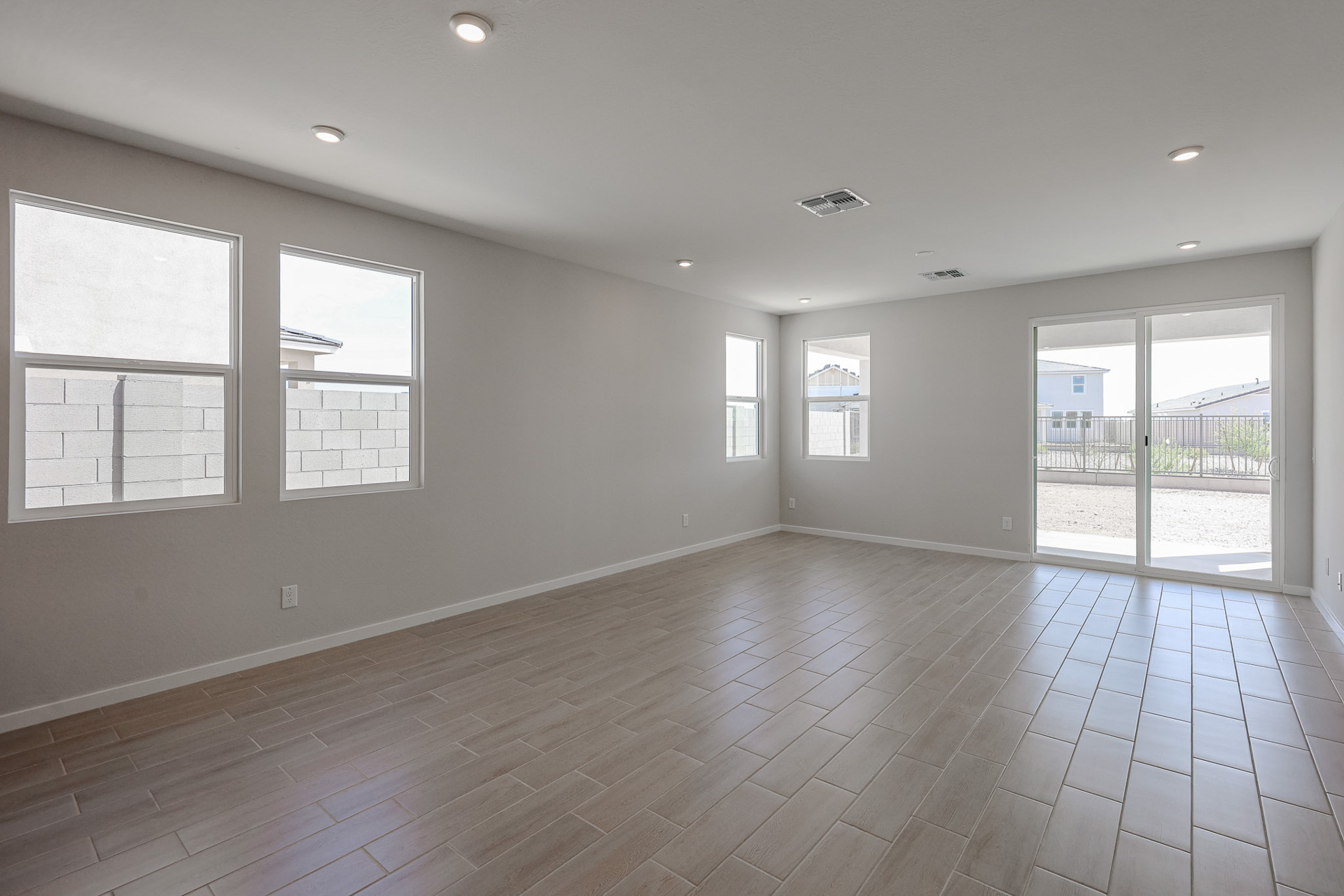 A room with windows and a wood floor.