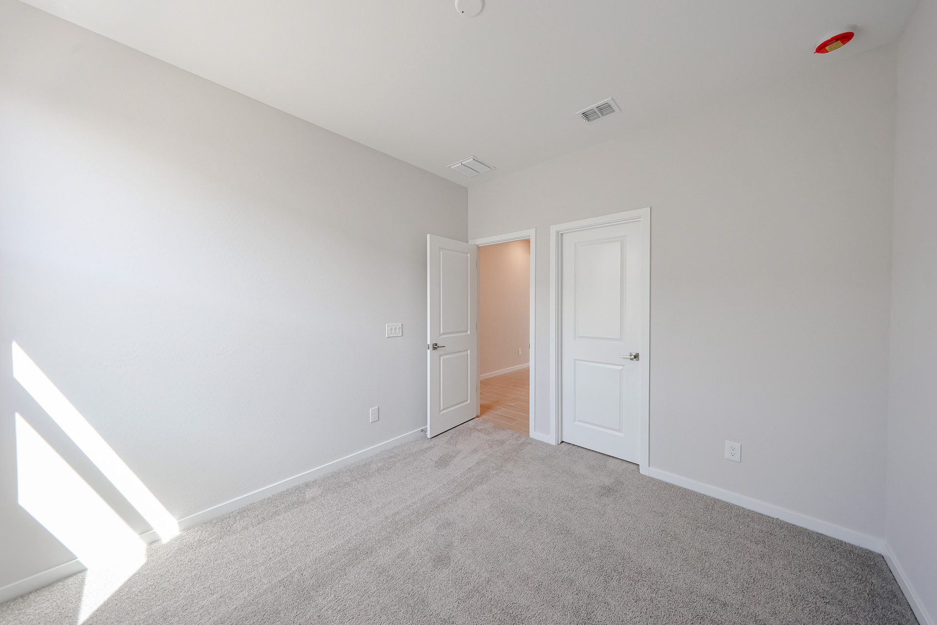 A hallway with white doors.